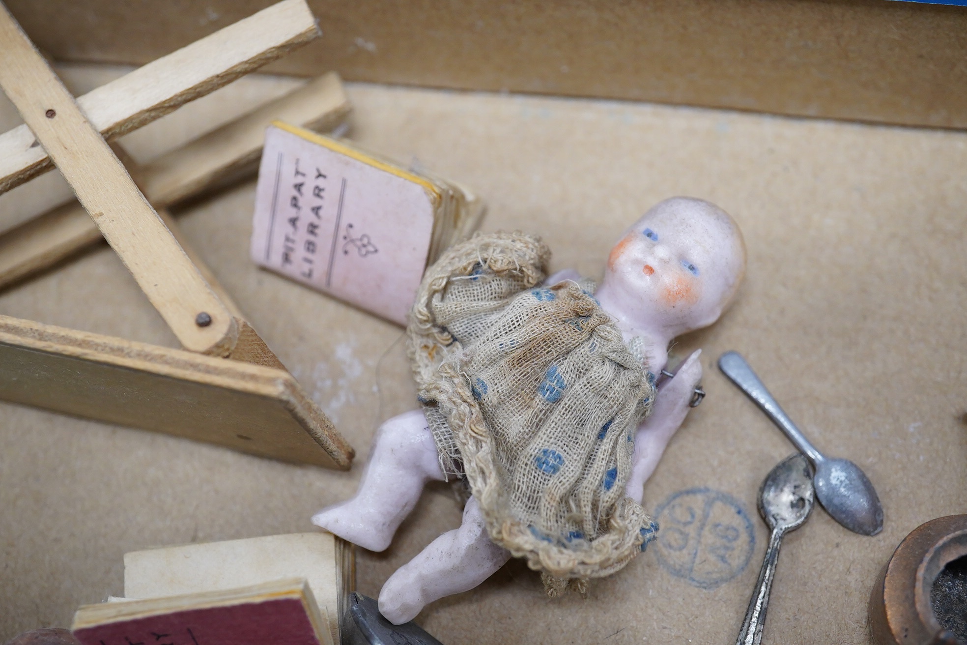 Eight early 20th century ceramic ‘doll's house’ dolls, approx 8cm long, with articulated limbs, together with a small quantity of doll house items by Pit-A-Pat series, etc. Condition - poor to fair.